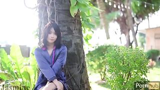 An Asian girl plays with a dildo and vibrator in the garden and squirts