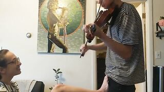 Girl trying to practice violin, but her boyfriend is jerking off instead