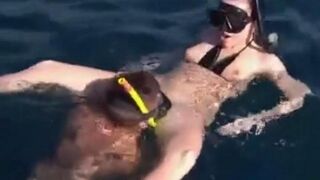 Underwater sex of two aqualangists at sea bottom