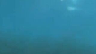 Underwater sex of two aqualangists at sea bottom