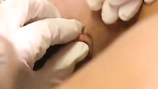 A girl with a nice pussy plays with her new clitoris piercing