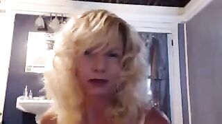 An aged girl caresses herself in the bathroom with a vibrator