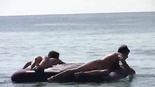 A naked girl is having fun on the beach without any clothes