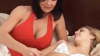 A young girl is having fun with her older girlfriend using a strapon