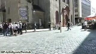 A girl has a walk with an open pussy in public place