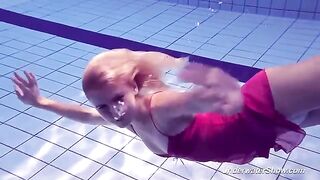 Helen has a swim in the pool without any clothes on