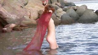 A girl with small boobs gets wet while walking naked