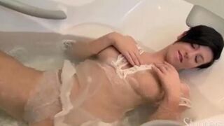 Lonely brunette caresses her pussy under the shower jet