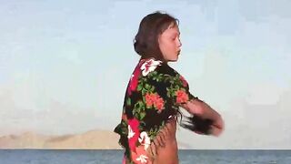 A member shows a girl at the nudist beach