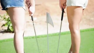 A girl is looking for a golf ball and gets lost in the grass with a lesbian