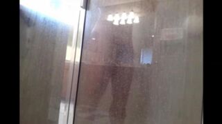 The man washes his body in the shower, not suspecting a thing