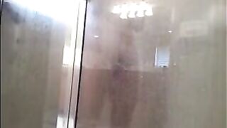 The man washes his body in the shower, not suspecting a thing