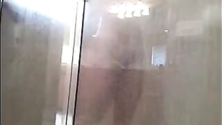 The man washes his body in the shower, not suspecting a thing