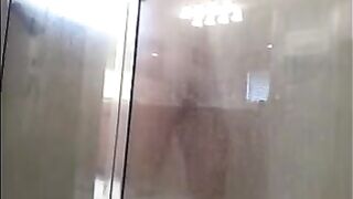 The man washes his body in the shower, not suspecting a thing