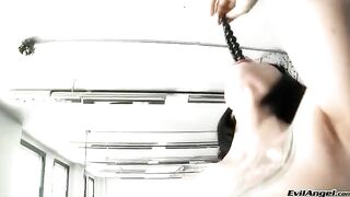 Wearing sexy high heels, the brunette plays with toys