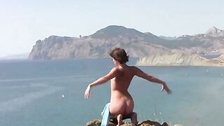 A girl is sunbathing naked on the beautiful beach