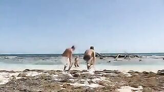 Blonde woman has sex with two guys on the sandy beach
