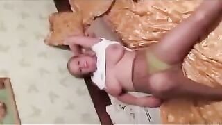 A pregnant woman has dropped her breasts in front of the photographer