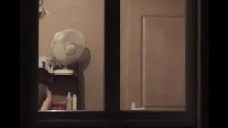 He looks at himself in the mirror completely naked