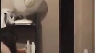 He looks at himself in the mirror completely naked