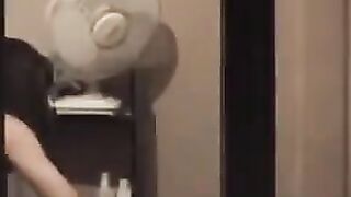 He looks at himself in the mirror completely naked