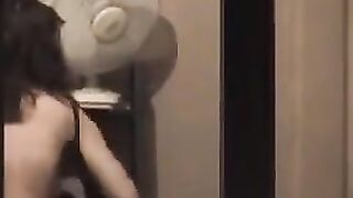 He looks at himself in the mirror completely naked