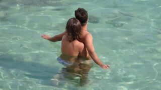 A girl fingers a guy’s cock while they’re underwater