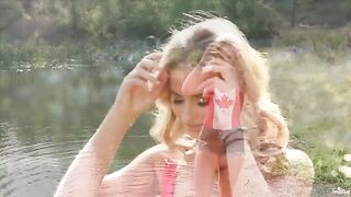 A blondie caresses herself tenderly by the lake