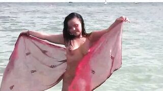 A moment of naked bathing in the sea, under the vast sky
