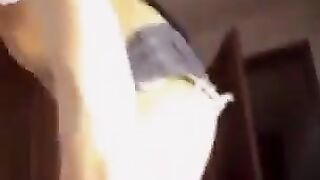 A nice woman with big natural boobs shows them off in the room