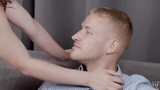 A sexy girl is giving herself to a man on the couch in a sensual scene
