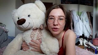 A cute girl has fun with her favorite teddy bear in the bedroom