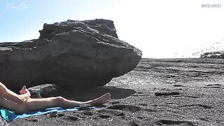 A girl shows her body on the nude beach to excite a man