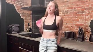 A sexual woman is fucking with a strong man in the kitchen