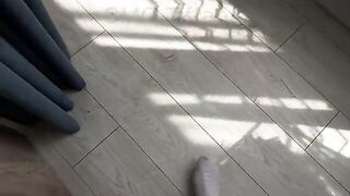 A cute 18-year-old girl is rolling on a bed sheet like a storm